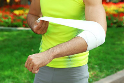 bandaged injured arm athlete exercising